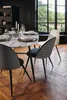 A dining table set with marble top and chairs in a room with a large window. Podgląd zdjęcia produktu