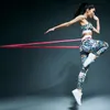 A woman is exercising with a resistance band. Náhľad obrázku produktu