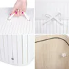 A collage of four close-up images showing details of a white bamboo laundry basket. Produktbild-Vorschau