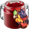A close-up of a glass jar filled with red jam, with a decorative lid featuring a fruit pattern. Another empty glass jar is visible in the background. Produktbild-Vorschau