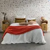 A bedroom scene with a bed, nightstands, and a patterned wall. Produktbild-Vorschau
