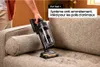 A person is using a cordless vacuum cleaner on a sofa. Náhled obrázku produktu