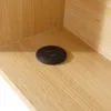 A close-up view of a black circular USB charging port with two USB-A ports embedded in a wooden surface. Náhled obrázku produktu
