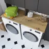 A laundry room with a washing machine and dryer, topped with a wooden counter. There are folded towels and jars of laundry supplies on the counter. Anteprima dell’immagine prodotto