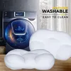 Two white pillows are placed in front of a washing machine, with text overlays indicating they are machine washable and easy to clean. Produktbild-Vorschau