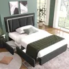 A bedroom with a bed, nightstand, and artwork on the wall. Náhled obrázku produktu