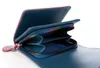 An open wallet with a rainbow zipper. Produktbild-Vorschau
