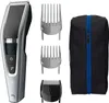 A product shot of a hair clipper set, including the clipper, multiple attachments, and a storage bag. Náhled obrázku produktu