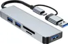 A silver USB hub with multiple ports and attached cables is shown against a white background. Produktbild-Vorschau