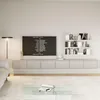 A modern living room with a TV mounted on a wall-mounted cabinet, shelves with books and decor, and a glass coffee table. Náhled obrázku produktu