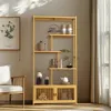 A wooden bookshelf with decorative items placed on its shelves, next to a chair and a window with curtains. Produktbild-Vorschau