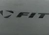 A close-up of the 'FIT' logo embossed on a textured gray surface. Produktbild-Vorschau