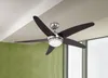 A ceiling fan with lights is mounted on a white ceiling, with a textured green wall and a window visible in the background. Produktbild-Vorschau