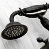 A close-up view of a vintage-style shower head and faucet handle. Anteprima dell’immagine prodotto