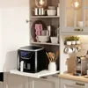 An air fryer is pulled out from a kitchen cabinet, with kitchenware and appliances visible in the background. Náhled obrázku produktu