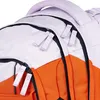 Close-up view of the zippers and handle of a backpack. Náhled obrázku produktu