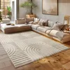 A modern living room with a large sectional sofa and a patterned rug.