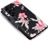 A close-up, angled view of a black flip phone case with a floral hibiscus pattern. Produktbild-Vorschau