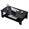 A black coffee table with a shelf underneath, a laptop, a vase with flowers, and a cup of coffee on it. Produktbild-Vorschau