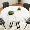 A round marble-patterned dining table with four dark gray chairs around it, set on a patterned rug in a dining room. Produktbild-Vorschau