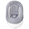 A close-up view of a gray baby bouncer seat with white trim and a white base. Produktbild-Vorschau
