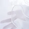 A hand is holding a sheer white fabric, showing the texture and hem. Produktbild-Vorschau