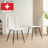 Two beige upholstered dining chairs with black metal legs are shown in a well-lit room with a light-colored wooden slatted wall in the background. Produktbild-Vorschau