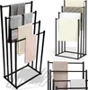 Multiple black metal towel racks with towels draped on them, shown from different angles. Produktbild-Vorschau