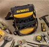 A DeWalt tool bag and various tools are laid out on a concrete floor. Anteprima dell’immagine prodotto