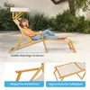 A woman relaxing on a wooden sun lounger with a canopy in an outdoor garden setting. Podgląd zdjęcia produktu