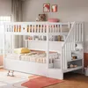 A white bunk bed with storage shelves and a pull-out bed, set up in a child's bedroom with toys and decor. Náhľad obrázku produktu