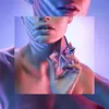 A close-up of a woman's neck and décolletage, holding a star-shaped perfume bottle. The image is lit with vibrant pink and blue lighting, creating a dramatic and artistic effect. Voir les images du produit