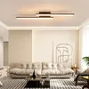 A modern living room with a sofa, coffee table, and abstract art on the wall, illuminated by a sleek ceiling light. Produktbild-Vorschau