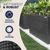 Two black rattan planters filled with green plants, placed on a lawn with white pebbles. Voir les images du produit