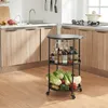 A kitchen scene with a rolling cart filled with vegetables and bottles of condiments. Voir les images du produit