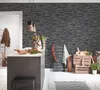 A kitchen island with a chalkboard menu and decorative items, set against a stone-effect wallpaper. Náhľad obrázku produktu
