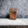 A product box for LED string lights is displayed on a concrete surface against a textured gray background. Produktbild-Vorschau