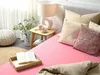 A bedroom scene with a bed, pillows, a lamp, and decorative items. Náhľad obrázku produktu