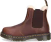 A side view of a brown Dr. Martens Chelsea boot with a white fuzzy lining. Produktbild-Vorschau
