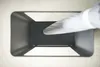 A hand in a white glove is inserting an object into a black umbrella stand. Produktbild-Vorschau