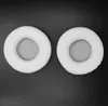 Two white circular headphone ear pads are shown on a black background. Náhled obrázku produktu