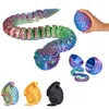 A collection of 3D printed snake toys in various colors and forms, including a long segmented snake and snakes coiled within egg-shaped containers. Voir les images du produit
