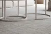 A close-up view of the base of two nesting coffee tables on a gray rug. Produktbild-Vorschau