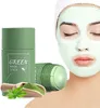 A woman with a green face mask applied, next to a green mask stick product and a wooden scoop with green powder and leaves. Náhled obrázku produktu