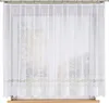 A white lace curtain hanging in front of a window. Náhled obrázku produktu