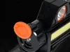 Close-up of a black headlamp with an orange button and a white LED strip. Produktbild-Vorschau