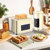A cream-colored toaster and kettle set are displayed on a kitchen counter, along with bread and toast. Produktbild-Vorschau