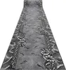 A long, narrow rug with a floral and fish pattern is shown from a diagonal perspective. Produktbild-Vorschau