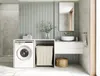 A modern laundry room or bathroom with a washing machine, sink, and storage. Produktbild-Vorschau