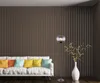 A modern living room with a white sofa, colorful pillows, and a floor lamp. Produktbild-Vorschau